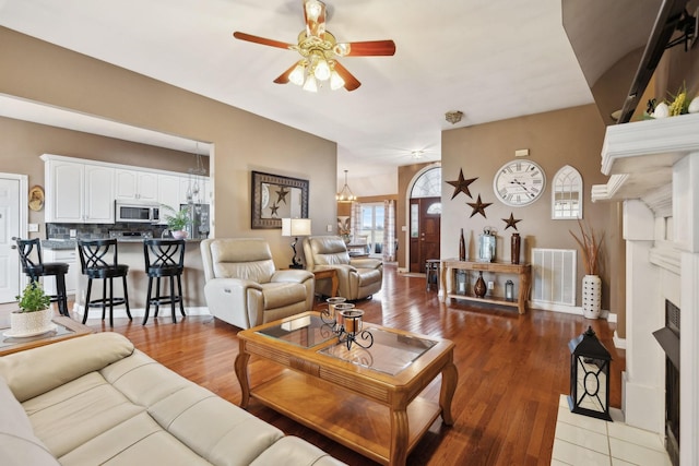 living room featuring ceiling fan and light wood-type flooring