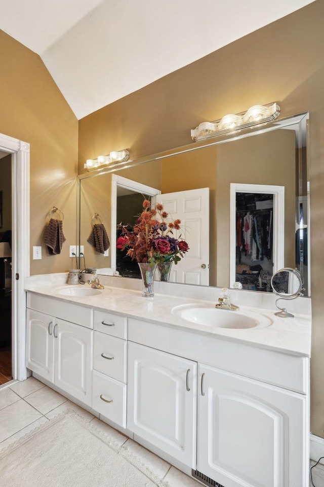 bathroom featuring tile patterned flooring, vanity, and lofted ceiling