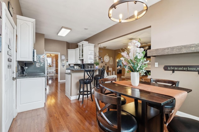 dining room with an inviting chandelier and light wood-type flooring