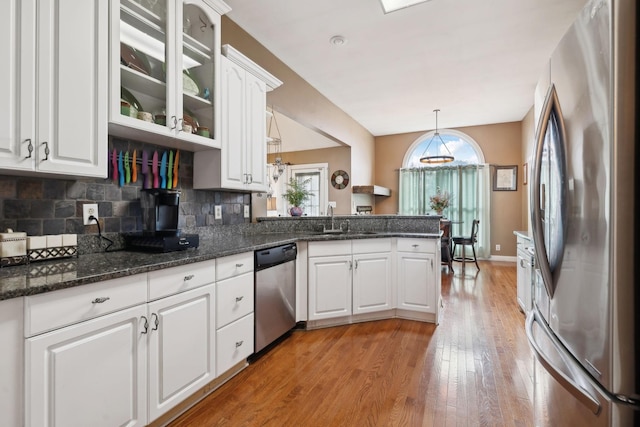 kitchen with sink, white cabinetry, decorative light fixtures, appliances with stainless steel finishes, and kitchen peninsula