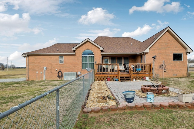 back of house with a wooden deck, central AC unit, and a lawn