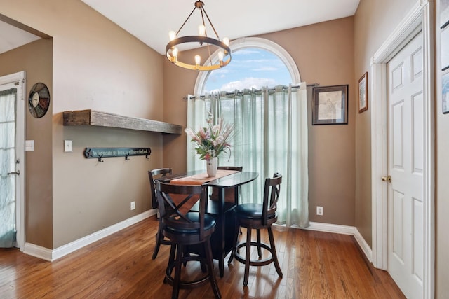 dining space featuring an inviting chandelier and hardwood / wood-style flooring