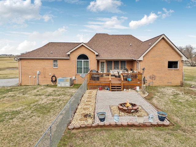 back of property featuring a wooden deck, a yard, cooling unit, and a fire pit