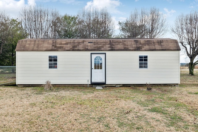 rear view of property with a yard