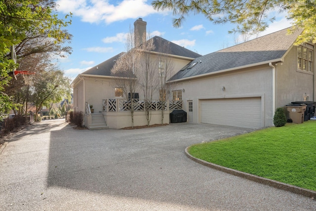 view of front of property featuring a garage and a front yard