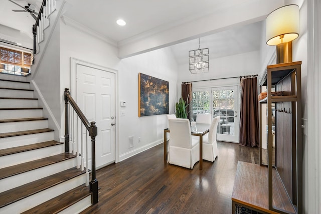 dining area with crown molding, dark wood-type flooring, and a chandelier