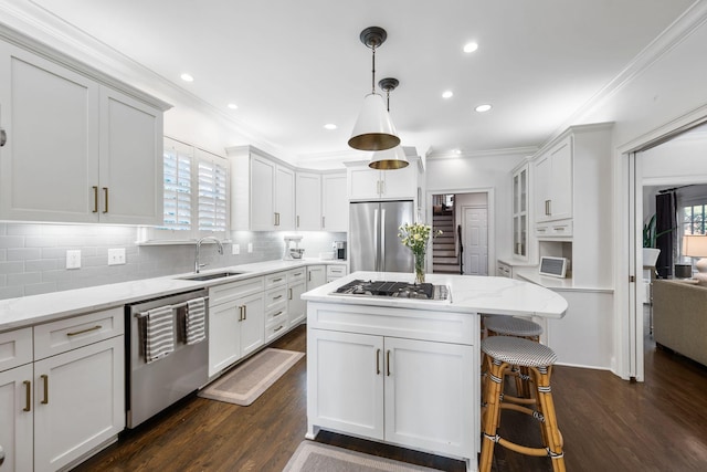 kitchen featuring sink, white cabinetry, stainless steel appliances, light stone counters, and a kitchen island