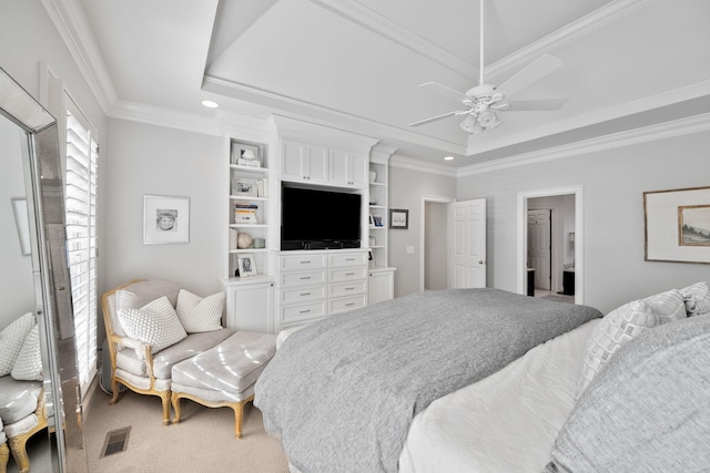 carpeted bedroom with ornamental molding, ceiling fan, and a tray ceiling