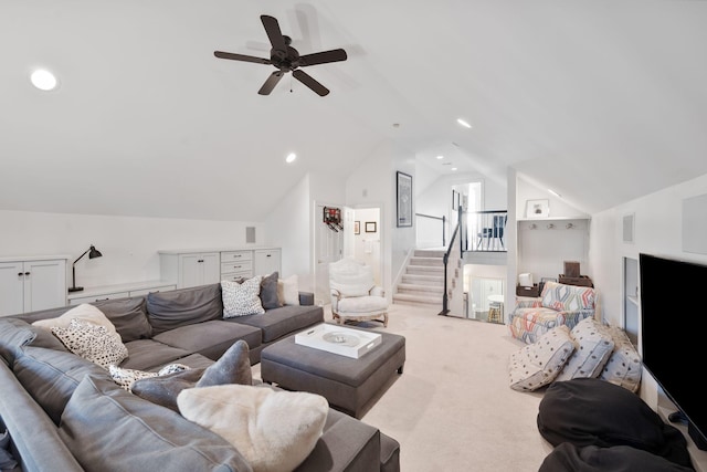 living room featuring lofted ceiling, light colored carpet, and ceiling fan