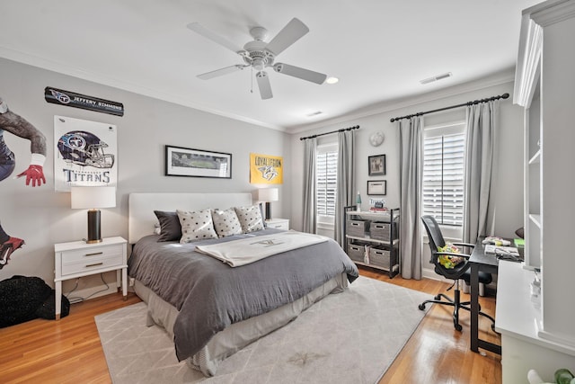 bedroom featuring ornamental molding, ceiling fan, and light wood-type flooring