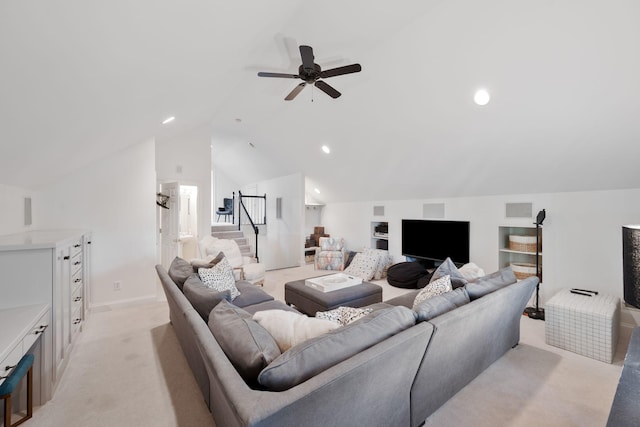 living room with built in features, vaulted ceiling, light colored carpet, and ceiling fan