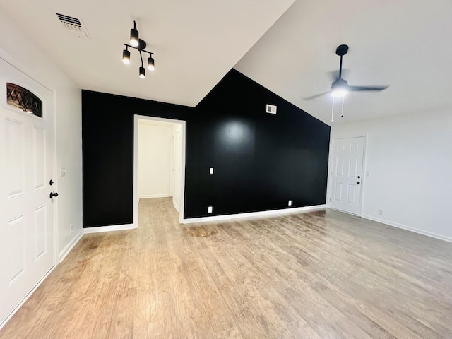 unfurnished room featuring vaulted ceiling, ceiling fan, and light wood-type flooring