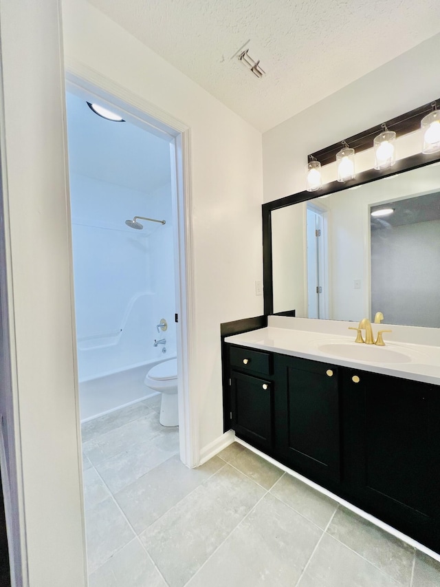 full bathroom featuring shower / bathing tub combination, tile patterned flooring, vanity, toilet, and a textured ceiling