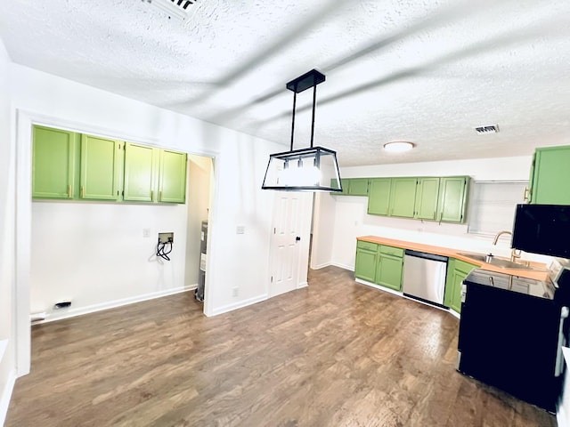 kitchen featuring dark wood-type flooring, sink, dishwasher, green cabinets, and pendant lighting