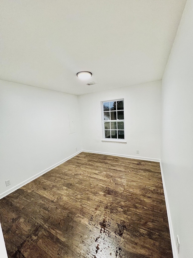 empty room featuring dark hardwood / wood-style flooring