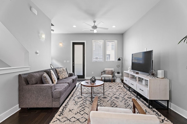 living room featuring dark hardwood / wood-style flooring and ceiling fan