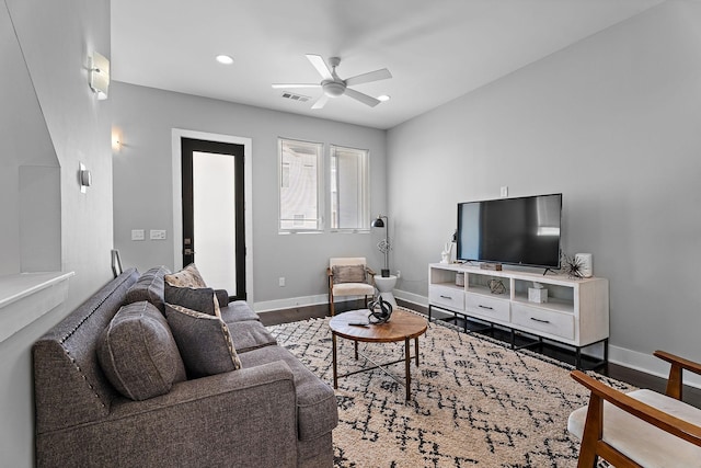 living room with wood-type flooring and ceiling fan