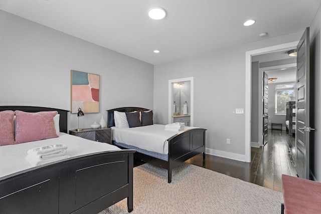 bedroom with dark hardwood / wood-style floors and ensuite bathroom