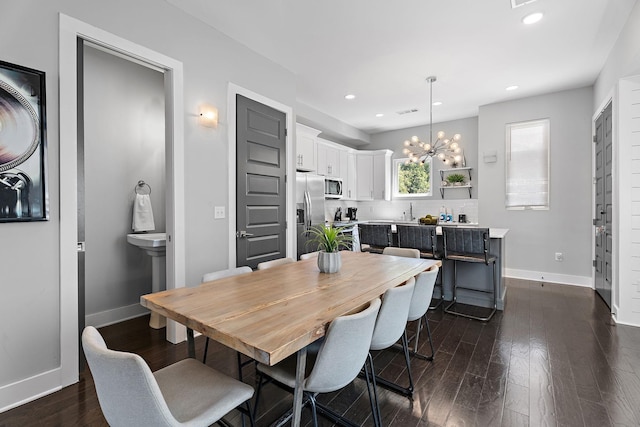 dining room featuring dark hardwood / wood-style floors and a notable chandelier