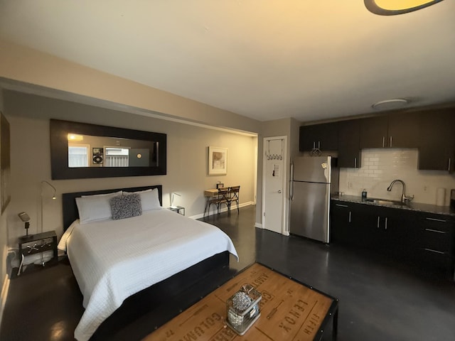 bedroom with sink and stainless steel refrigerator