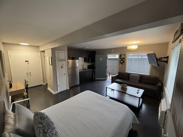 bedroom with sink and stainless steel fridge