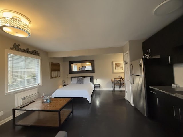 bedroom featuring stainless steel fridge