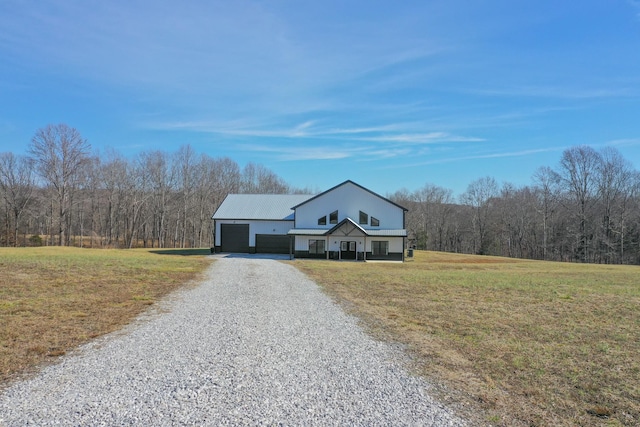 view of front of property with a garage and a front lawn