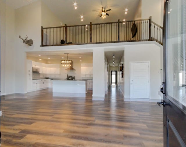 living room with a towering ceiling and hardwood / wood-style floors