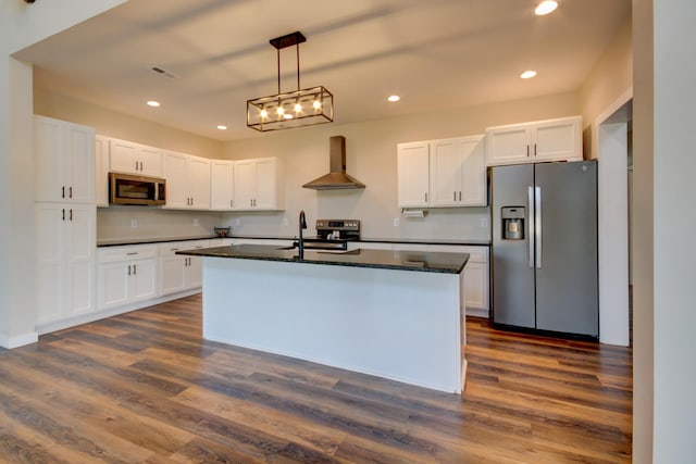 kitchen with white cabinetry, dark hardwood / wood-style flooring, wall chimney exhaust hood, and appliances with stainless steel finishes