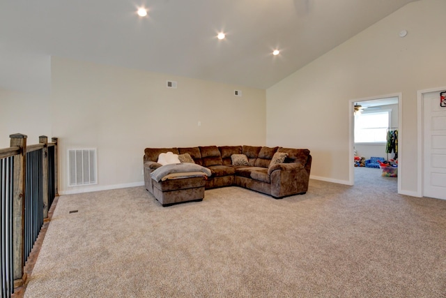 carpeted living room featuring high vaulted ceiling