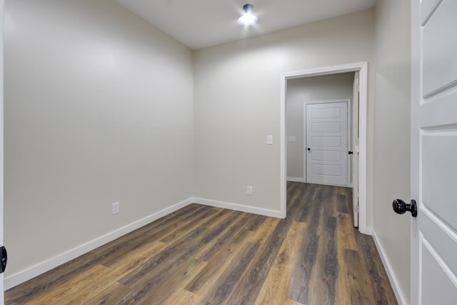 unfurnished room featuring dark wood-type flooring