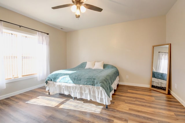 bedroom with hardwood / wood-style floors and ceiling fan