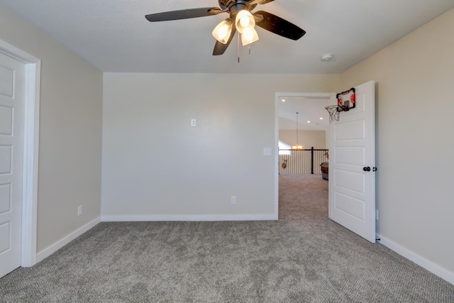 empty room featuring light colored carpet and ceiling fan