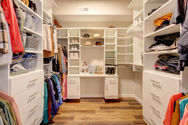 spacious closet with light hardwood / wood-style flooring