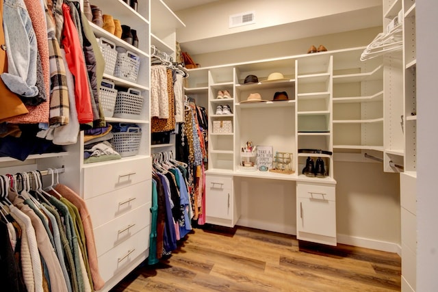 spacious closet featuring light hardwood / wood-style floors