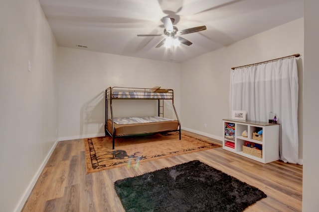 bedroom with hardwood / wood-style floors and ceiling fan