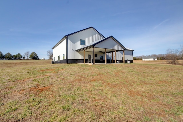 rear view of house featuring a yard