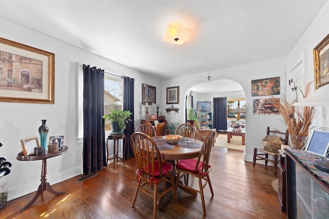 dining space featuring dark wood-type flooring