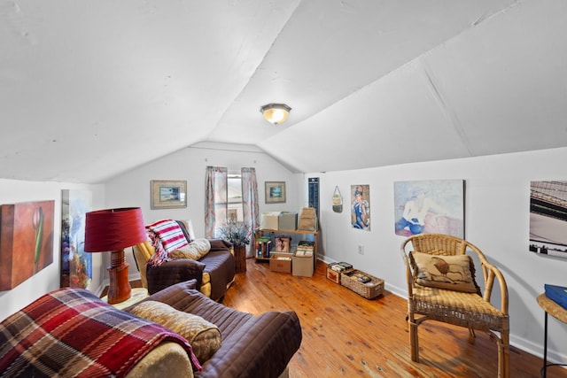 living room featuring light hardwood / wood-style floors and vaulted ceiling