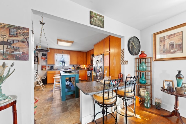 kitchen featuring a kitchen breakfast bar and appliances with stainless steel finishes