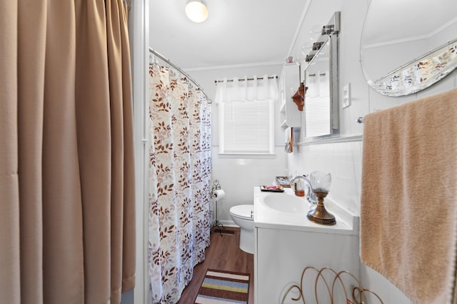 bathroom featuring ornamental molding, vanity, toilet, and wood-type flooring