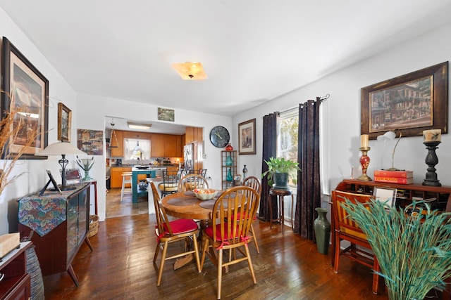 dining space with dark hardwood / wood-style flooring