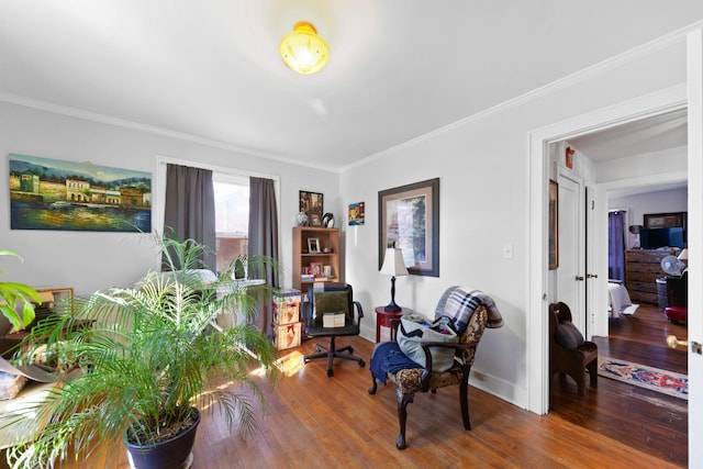 living area featuring crown molding and wood-type flooring