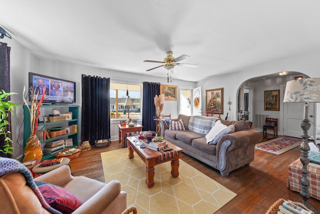 living room with wood-type flooring and ceiling fan