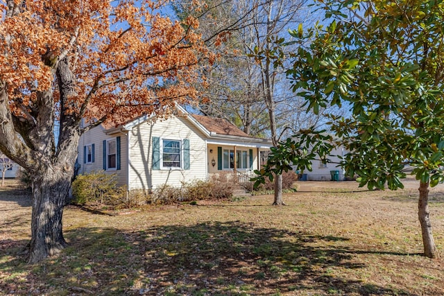 view of front of home with a front yard and a porch