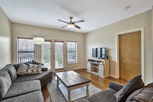 living room featuring hardwood / wood-style floors, french doors, and ceiling fan