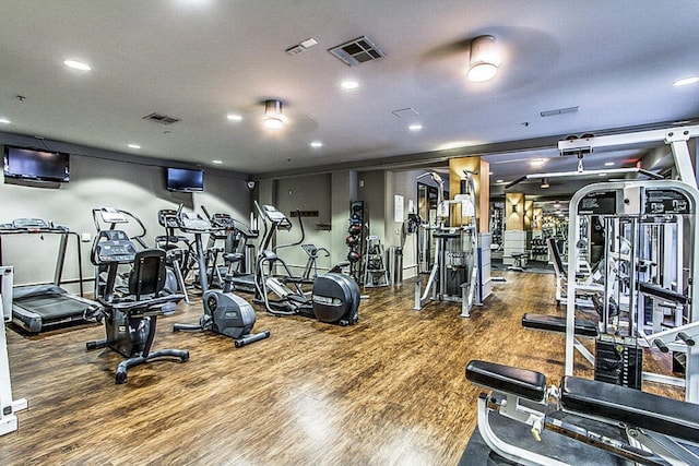 workout area with hardwood / wood-style floors