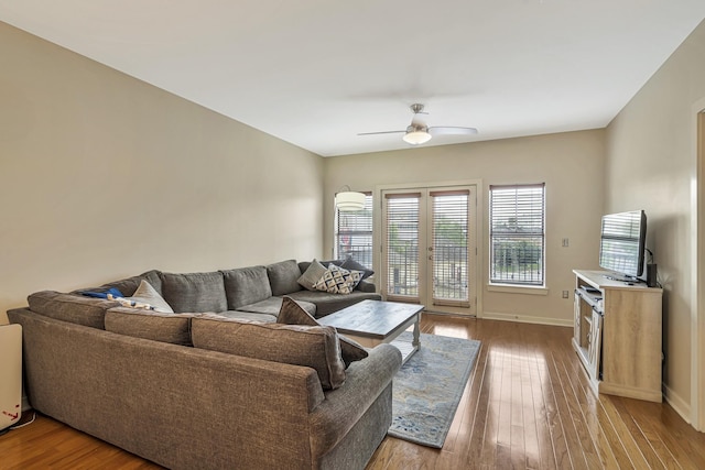 living room with light hardwood / wood-style flooring, french doors, and ceiling fan