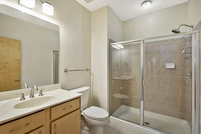 bathroom with vanity, a shower with shower door, and toilet