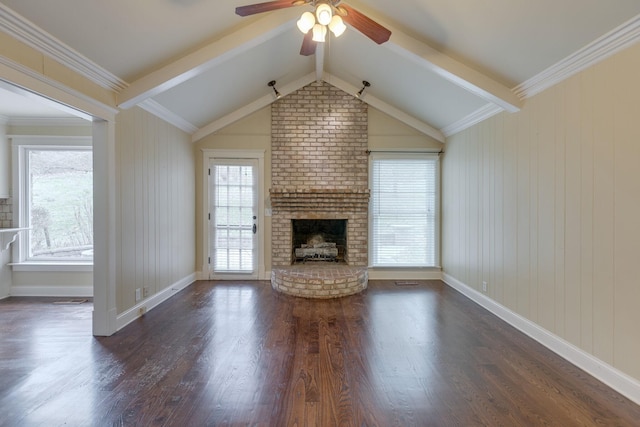 unfurnished living room with dark hardwood / wood-style floors, vaulted ceiling with beams, ornamental molding, ceiling fan, and a brick fireplace